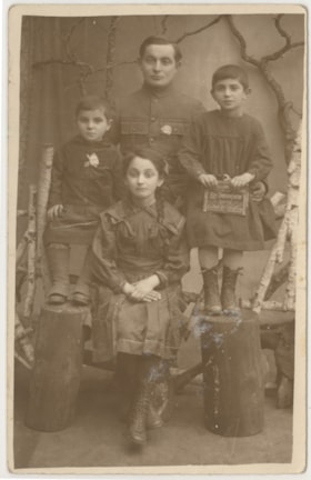Group portrait of a man, a boy and two girls