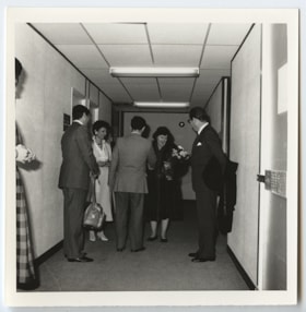 Unidentified group of people standing in a hallway