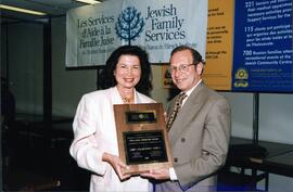 Interior group portrait, Avrum Orenstein, vice-president of Federation CJA presenting Libby Volodarsky Labell with the Orenstien Award at Jewish Family Services' annual meeting. Labell, past president of JFS of the Baron de Hirsch Institute, was honoured for her outstanding service to the Jewish community and the community at large.