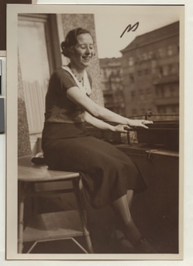 Gertrude sitting on a balcony