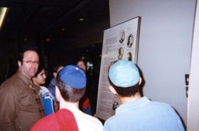 Dr. Harry Prizant touring the exhibit Visas for Life with school children.