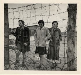 Three women behind barbed wires at Bergen-Belsen