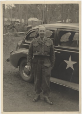 Man in Military Uniform in front of Military Car