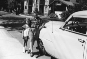 Beverly and Murray Allice standing beside a car