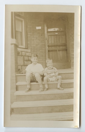 Stan Abelson and Bobby Abelson on the front step.