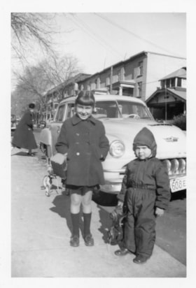 Beverly Allice and Gordon Allice beside a car