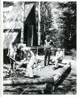Group portrait of boys working on fire pit, Camp Wooden Acres, Montreal.