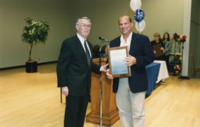David Greenberg receives a plaque for the Lillian Raport Endowment Fund from President Norman Lesh.