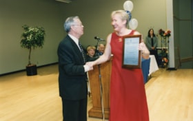Barbara Crook receives a plaque for the Barbara Crook and Dan Greenberg Endowment Fund from President Norman Lesh