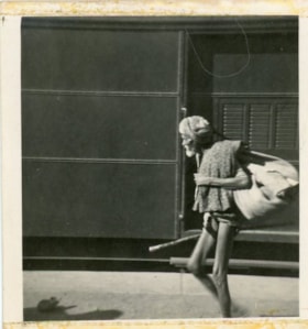 Thin man beside a train