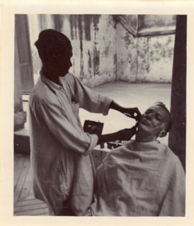 Danny Thacker getting his face shaved