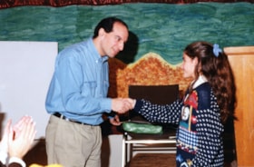 JCC President Ron Prehogan congratulates JCC poster winner Amanda Shore
