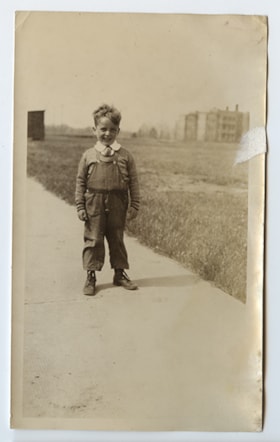Young boy in overalls.