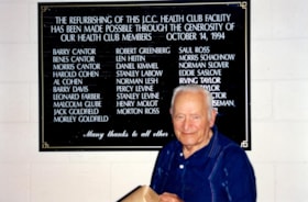 Long-time member Benes Cantor inspects the plaque commemorating the refurbishing of the Jewish Community Centre Health Club