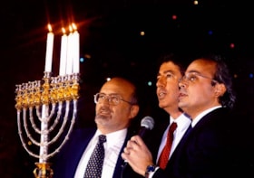 Rabbi Reuven Bulka, Israeli Ambassador Chaim Divon, and Cantor Daniel Benlolo light the menorah for Chanukah at a celebration held on Parliament Hill.