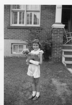 Beverly Allice holding a stuffed dog