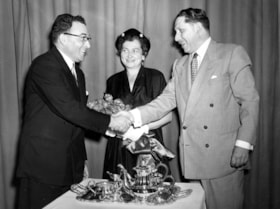 Rabbi and Mrs. Emanuel Lifschutz receive a silver tea set and flowers from President of the Ottawa Va'ad Ha'Ir Sam Berger