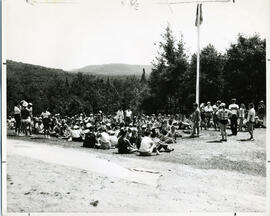 Group portrait of campers sitting on lawn near flagpole, Camp Wooden Acres, Montreal.
