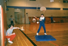 Two unidentified men playing indoor softball
