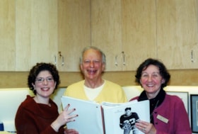 Marcia Mordfield, Lawrence Freedman, and Dawn Logan holding the Ottawa Sports Hall of Fame presentation on Joe Zelikovitz.