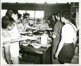 Group portrait of campers gathering around table for food, Camp Wooden Acres, Montreal.