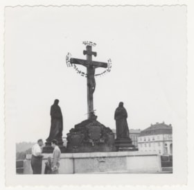 Men in Front of Statue of St. Calvary at Charles Bridge