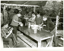 Group portrait of people working in outdoor kitchen, Camp Wooden Acres, Montreal.