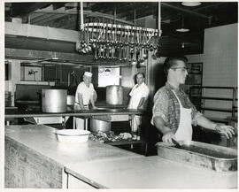 Interior shot, kitchen, three staff members included, Camp Wooden Acres, Montreal.