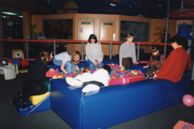 People in a ball pit at Cosmic Adventure for a Chanukah event