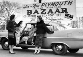 Roz Barrett, Freda Lithwick, and Jeanne Horwitz standing with a new Plymouth that was to be raffled at the Ottawa Hadassah Wizo Bazaar.