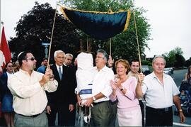 Exterior group snapshot, Jerry Schwartz holding sefer Torah during procession from Congregation Beth Tikvah. At his side is wife Harriette and Rabbi Mordecai Zeitz.