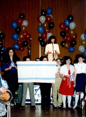 Nine photographs of the Jewish Community Yom Ha'atzmaut celebration held at the Skyline Hotel.