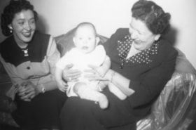 Mary Allice holding a baby with an unidentified woman