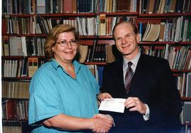 Interior group portrait, Bialik High School vice-principal presenting cheque to Stanley Plotnick, president of Federation CJA. Students at Bialik High School raised $2,239 for Combined Jewish Appeal, by washing cars and pumping gas at their annual Gazorama.